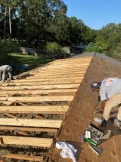 Crew framing and decking a roof during a renovation project